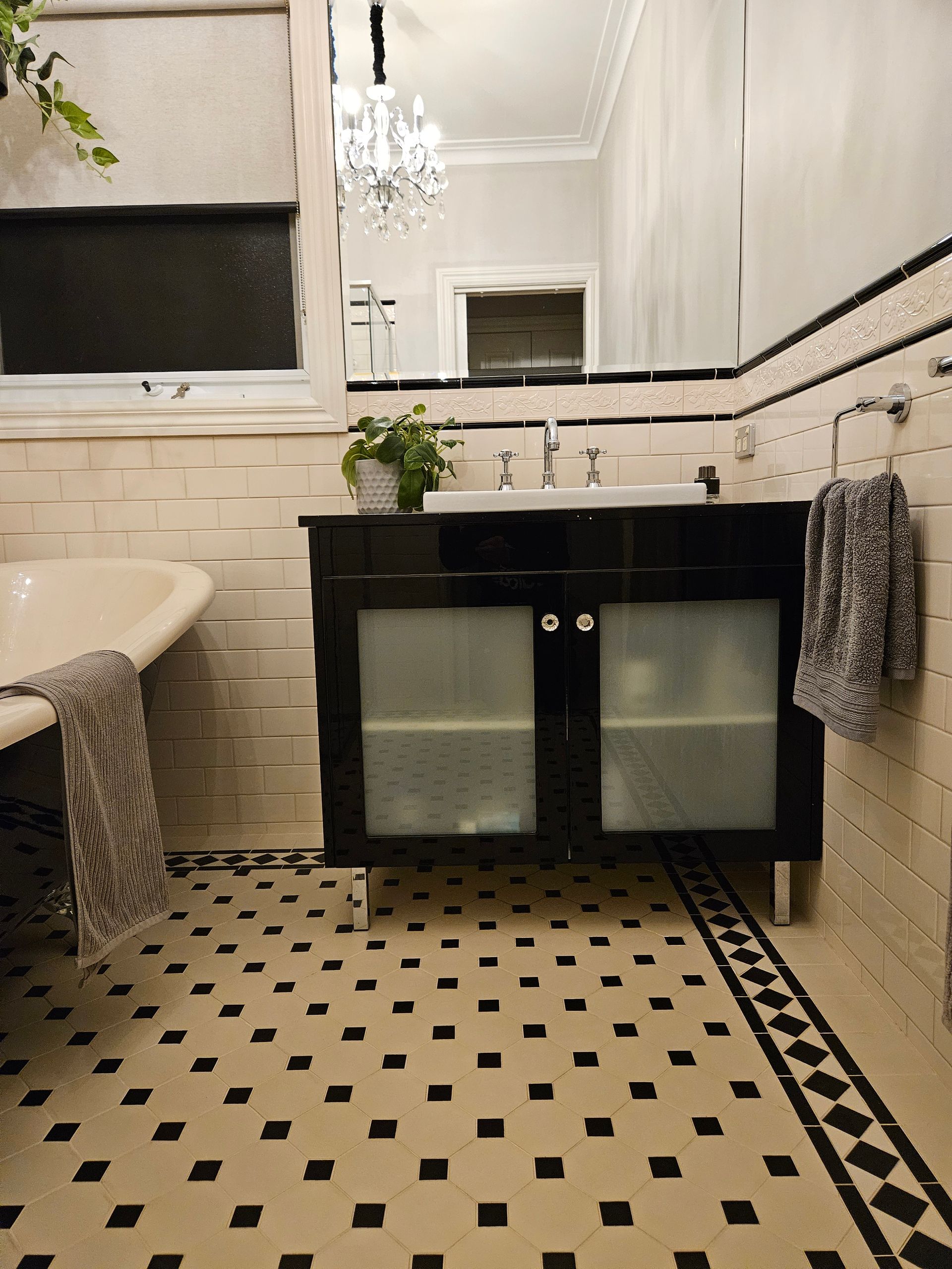 A bathroom with a black and white checkered floor