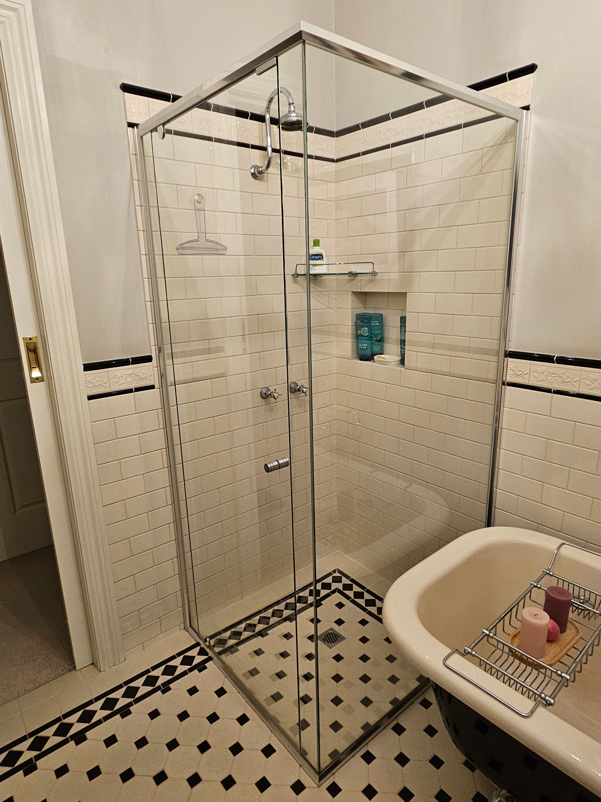 A bathroom with a bathtub and a shower stall