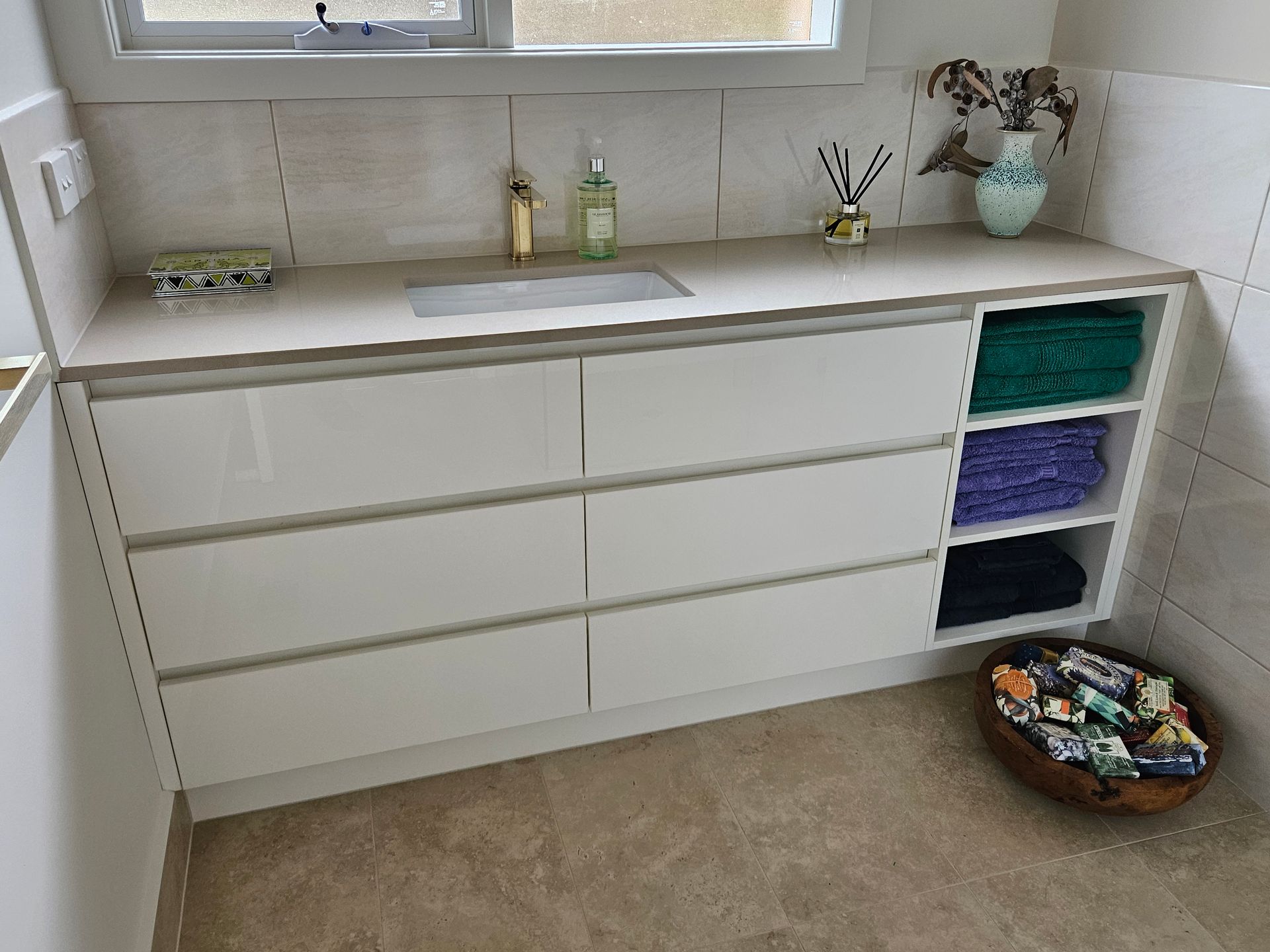A bathroom with white cabinets and a sink.