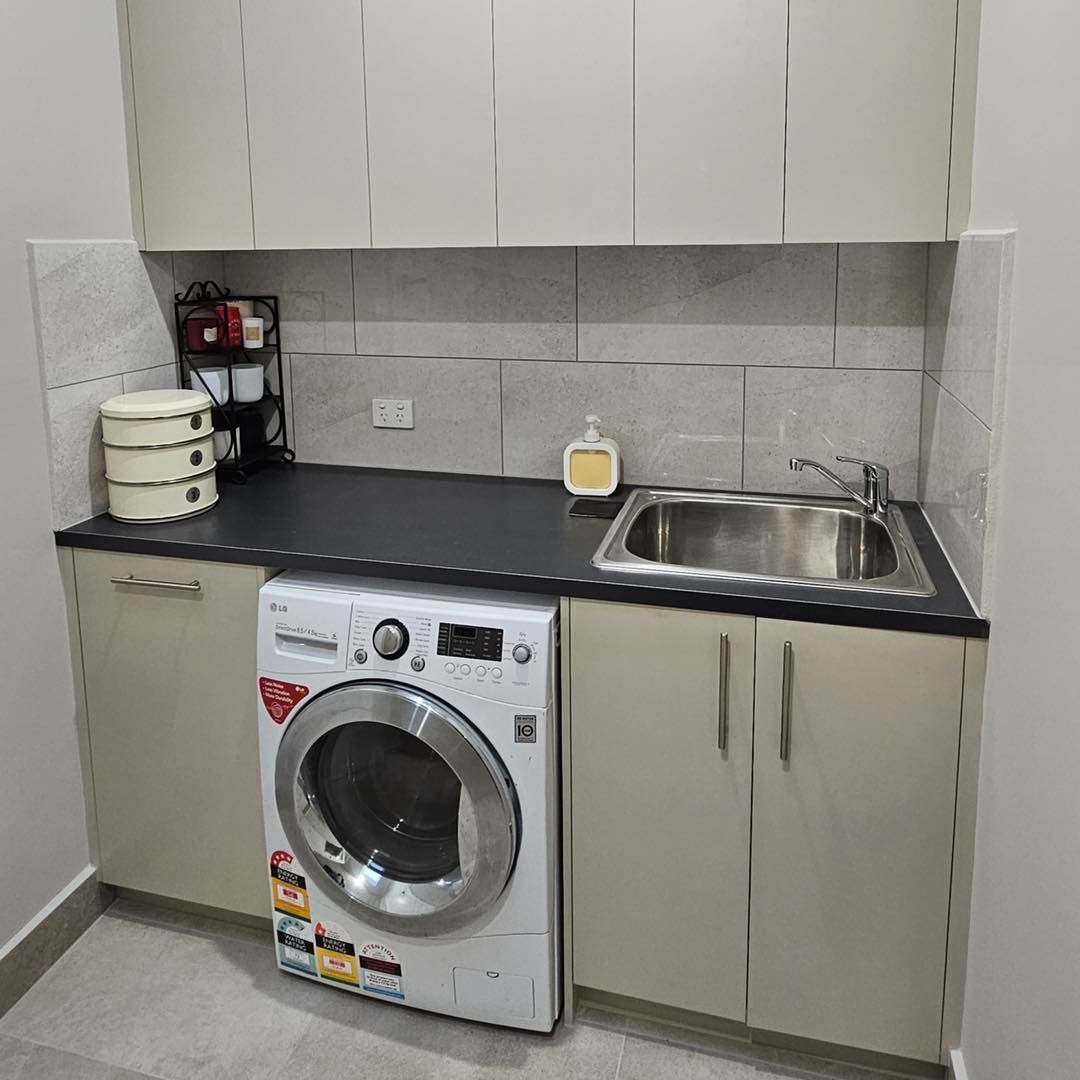A Laundry Room With A Washer And Dryer And A Sink – Melbourne, VIC - Deluxe Bathrooms & Tile Centre