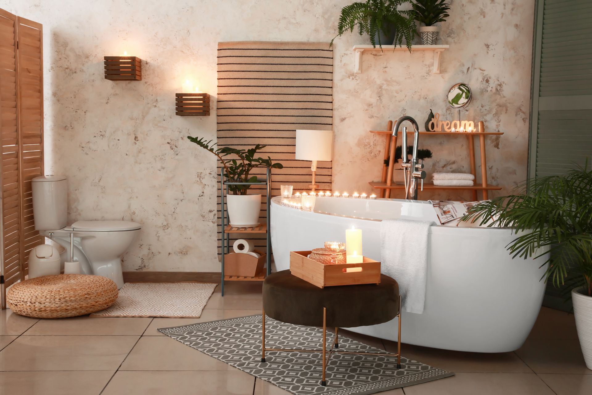 Interior of a modern bathroom with burning candles, plants, and wooden accents.