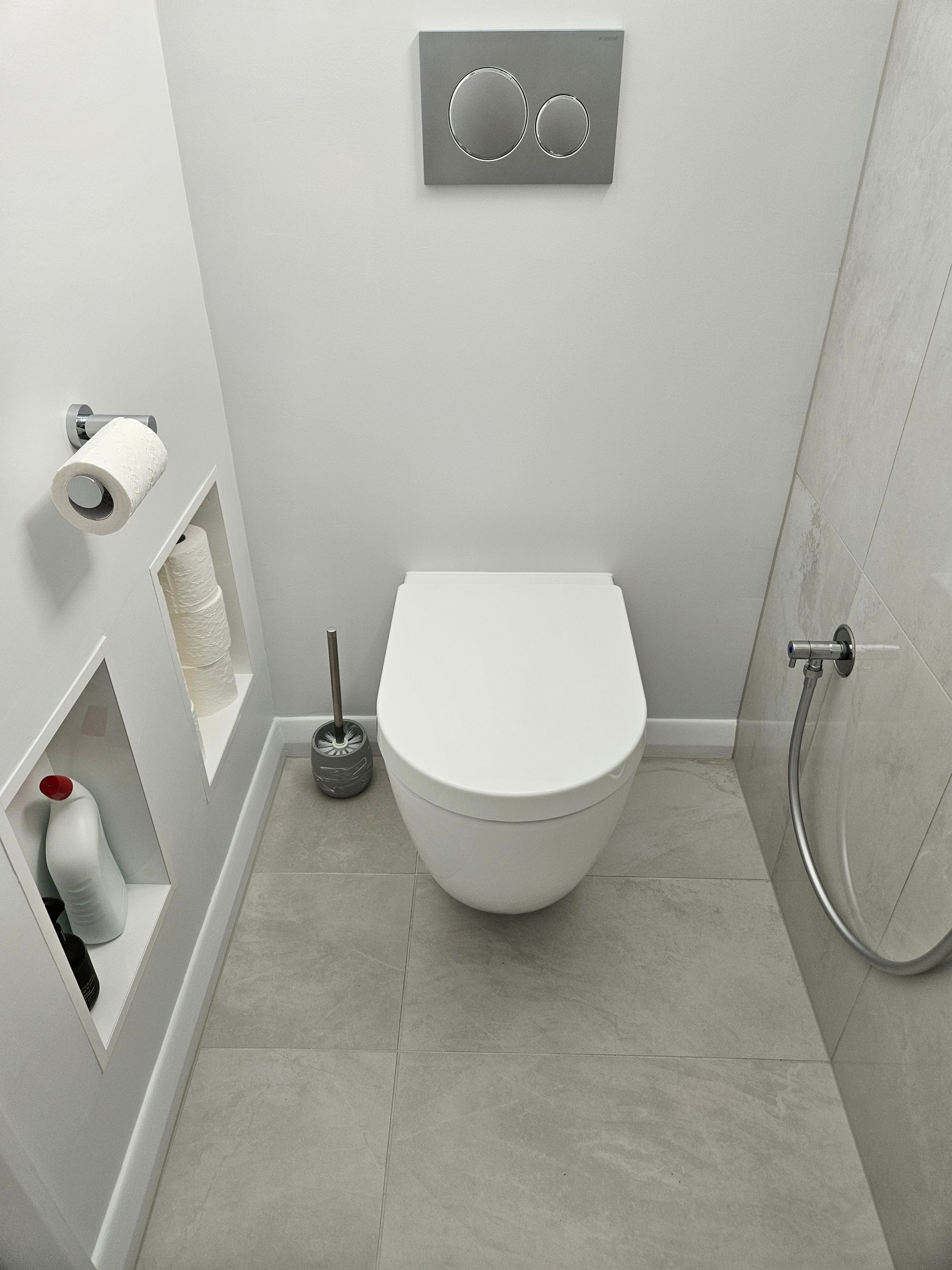 A small bathroom with a toilet and a shower.