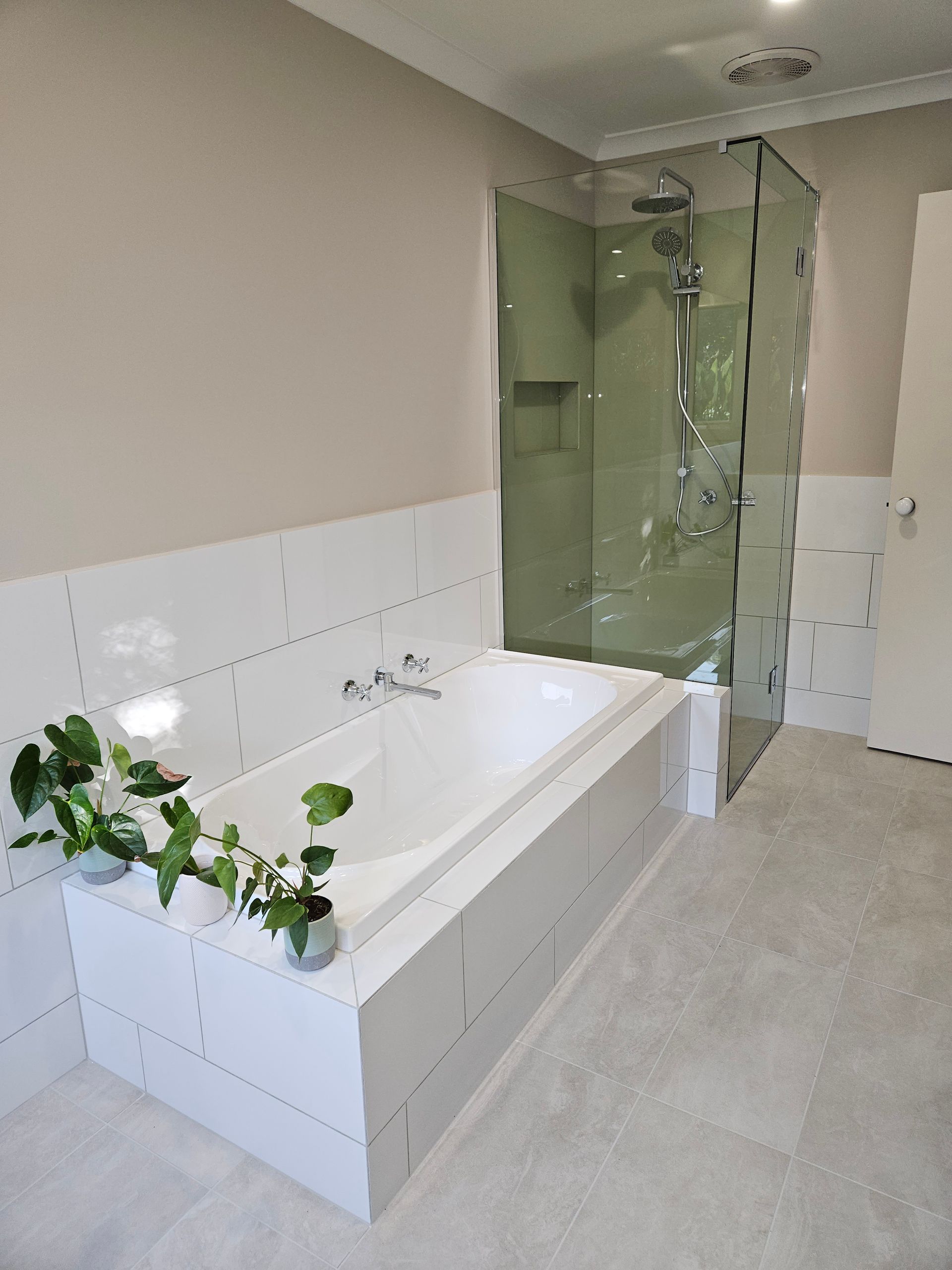 A bathroom with a bathtub and a walk in shower.