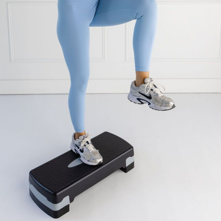 A woman does pilates on a pilates reformer