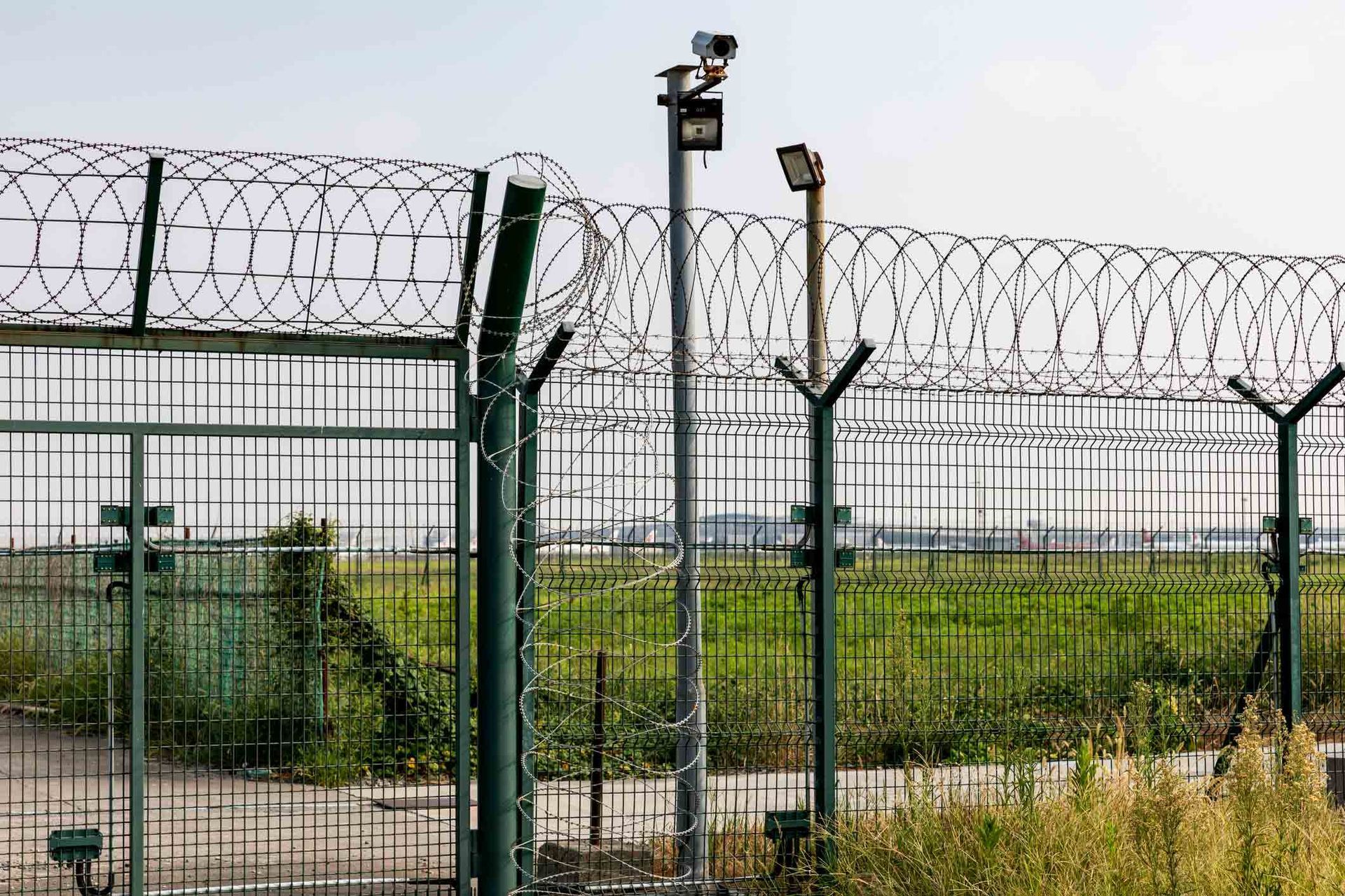 A Barbed Wire Fence Surrounds a Grassy Field | Cranbourne, VIC | Cranbourne Fencing Pty Ltd
