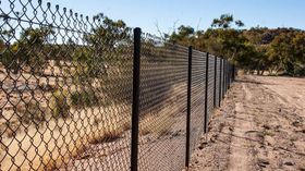 A Chain Link Fence Surrounds a Dirt Road | Cranbourne, VIC | Cranbourne Fencing Pty Ltd