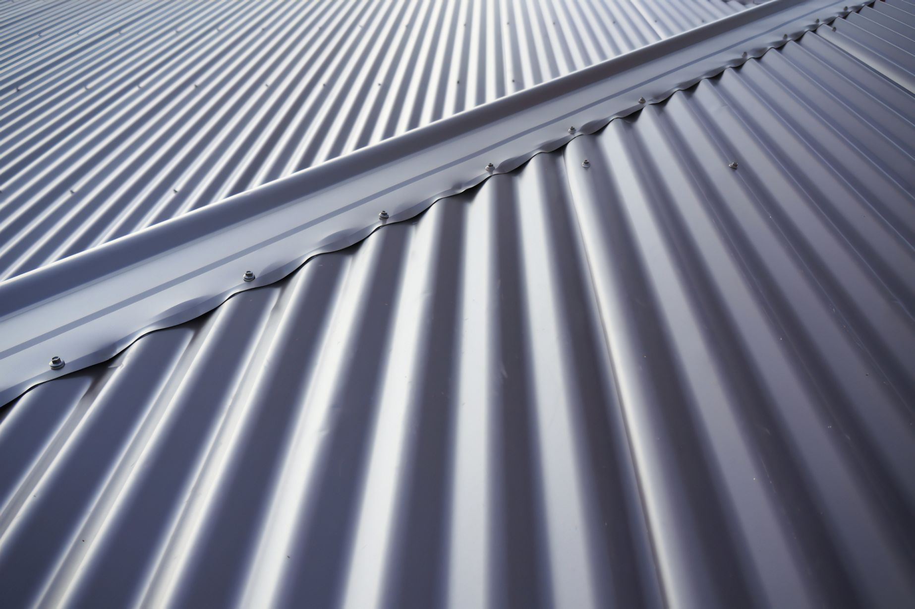 A Close Up of a Metal Roof With a Diagonal Pattern — Stormguard Roofing In Caloundra West, QLD