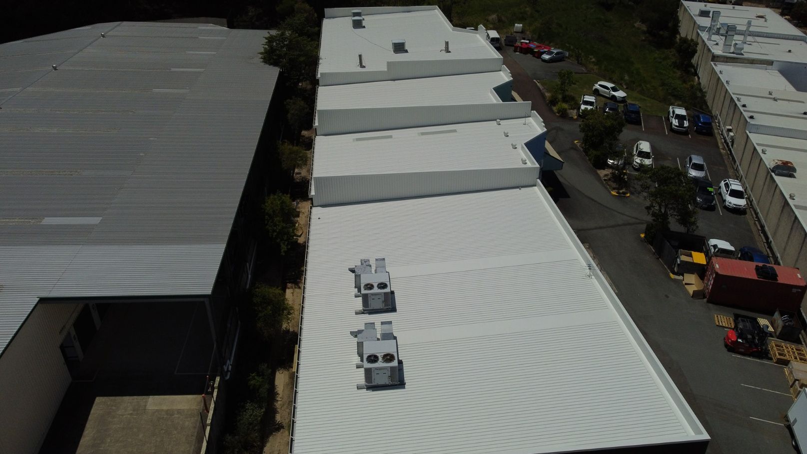 An Aerial View of a Building With a White Roof — Stormguard Roofing In Caloundra West, QLD