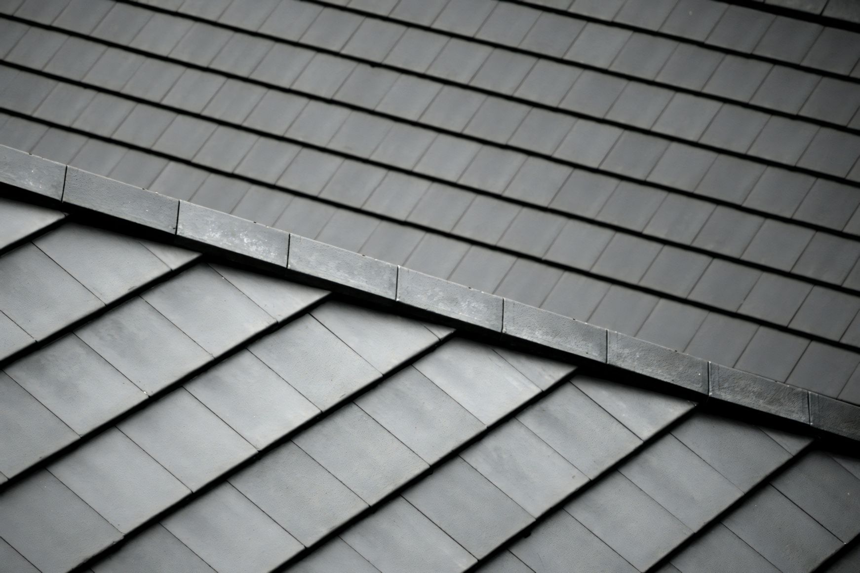 A Close Up of a Black Tiled Roof — Stormguard Roofing In Caloundra West, QLD