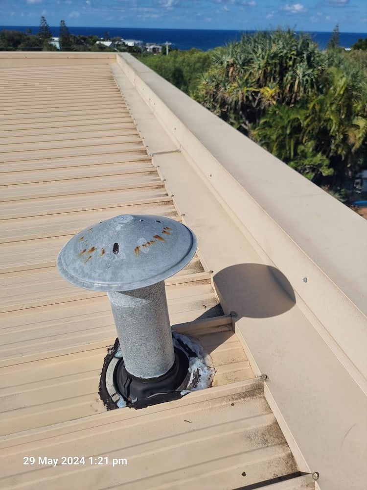 A Roof With a Chimney on It and a View of the Ocean — Stormguard Roofing In Maroochydore, QLD