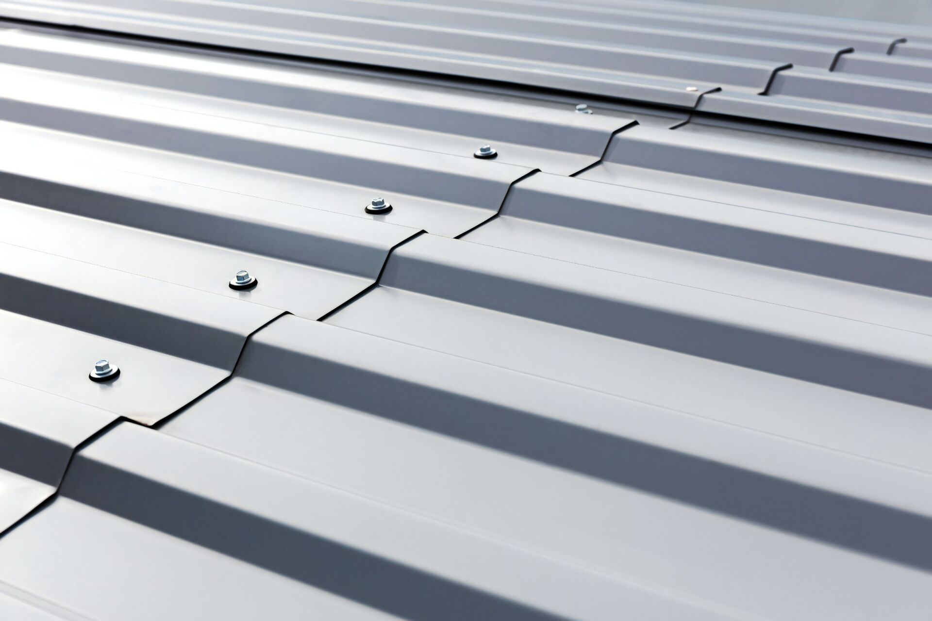 A Close Up of a Metal Roof With Screws on It — Stormguard Roofing In Caloundra West, QLD