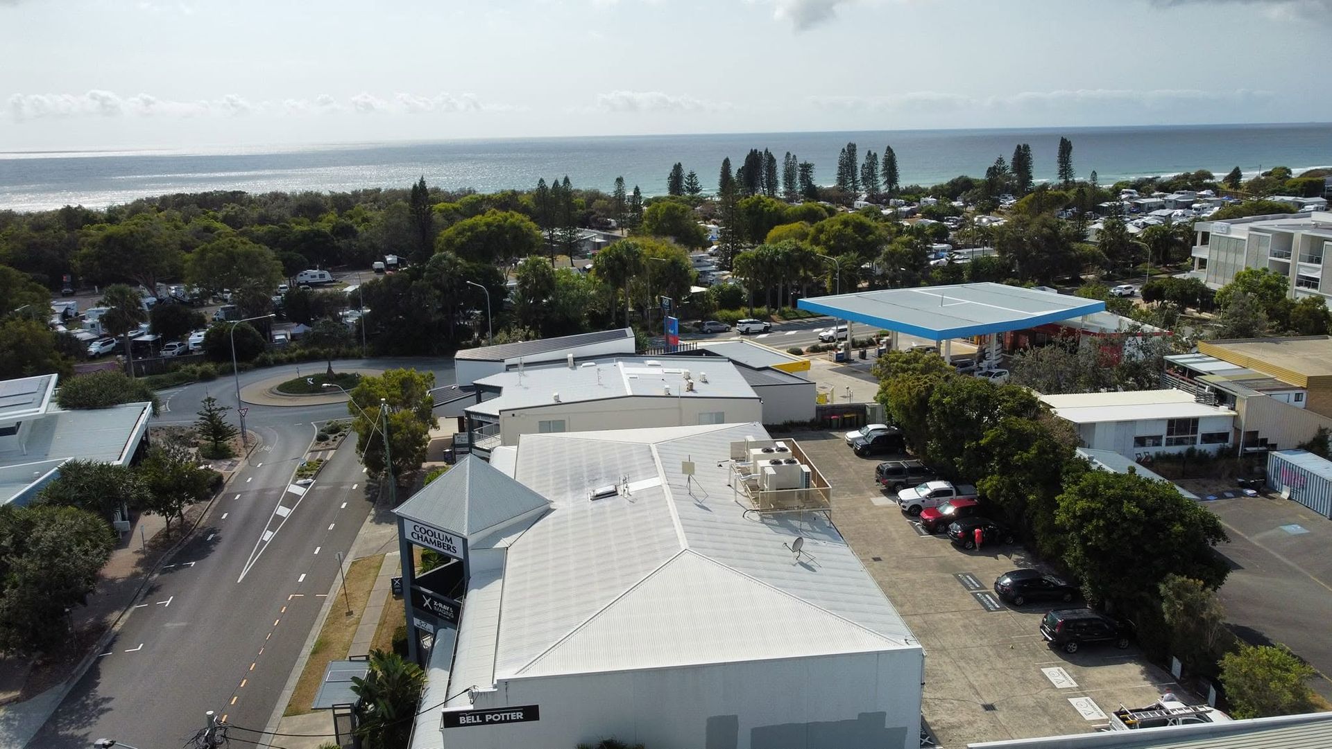 Aerial View of a Coastal Neighborhood With White Rooftops — Stormguard Roofing In North Lakes, QLD