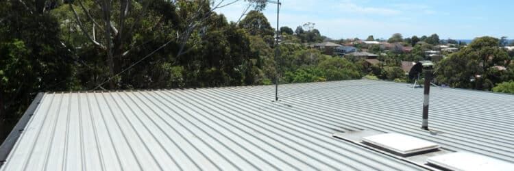 A Roof With a Chimney on It and Trees in the Background — Stormguard Roofing In Caloundra West, QLD