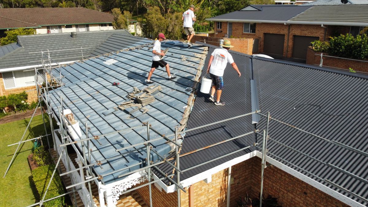 An Aerial View of a House With a White Roof in a Residential Area — Stormguard Roofing In Caloundra West, QLD