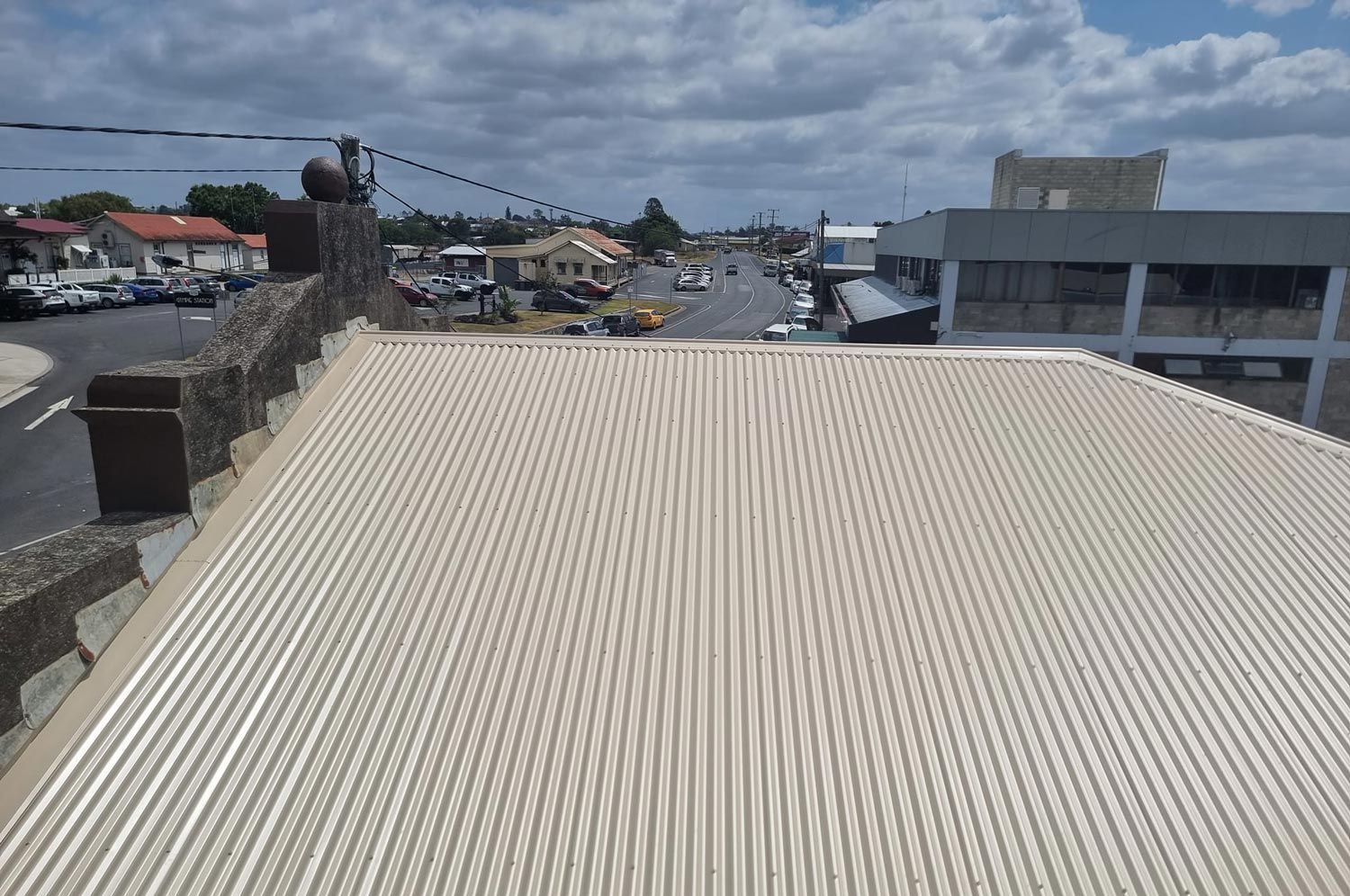 A Rooftop View of a City With a White Roof — Stormguard Roofing In Caloundra West, QLD