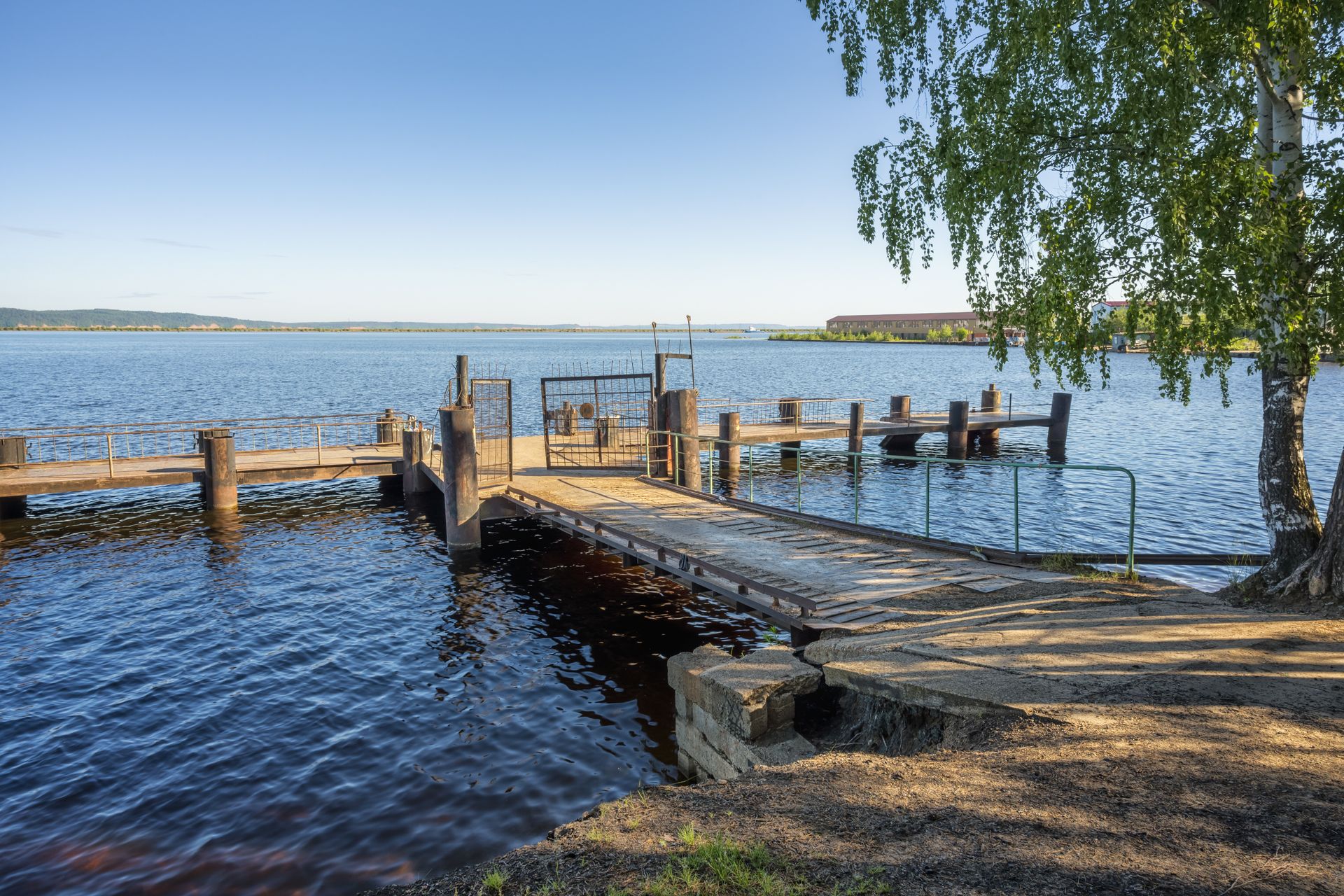 There is a wooden dock in the middle of a lake.