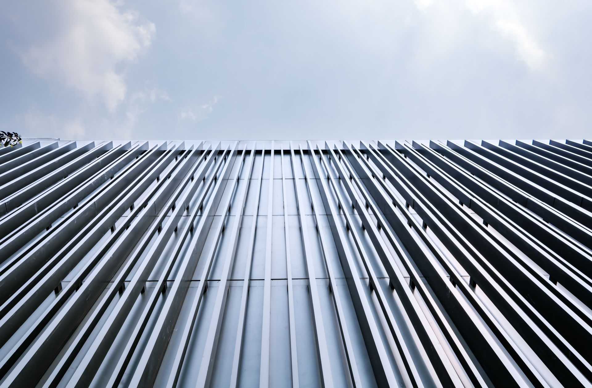Looking up at a tall building with a blue sky in the background