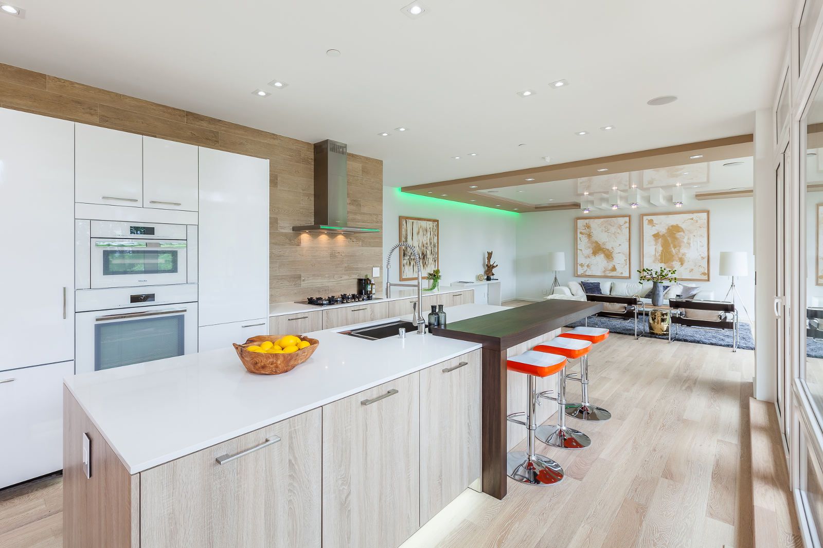 A kitchen with white cabinets and a large island in the middle.