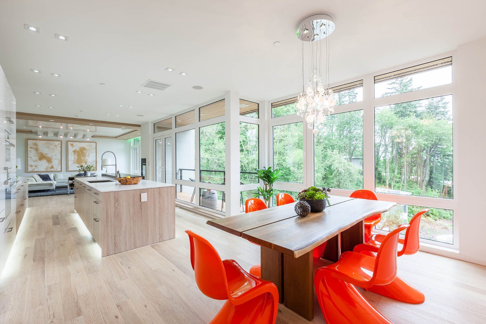 A dining room with a wooden table and orange chairs