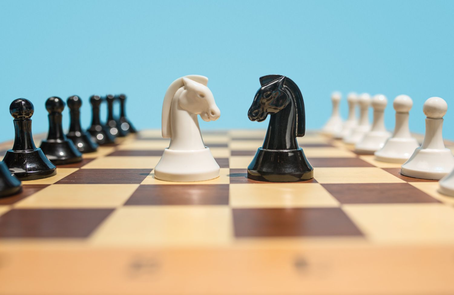 A chess board with black and white chess pieces on it.