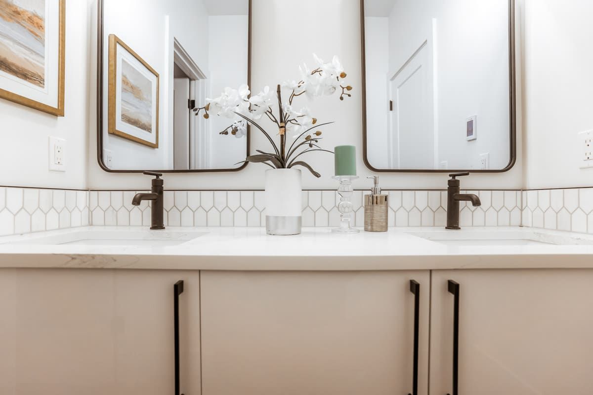 A bathroom with two sinks and two mirrors.