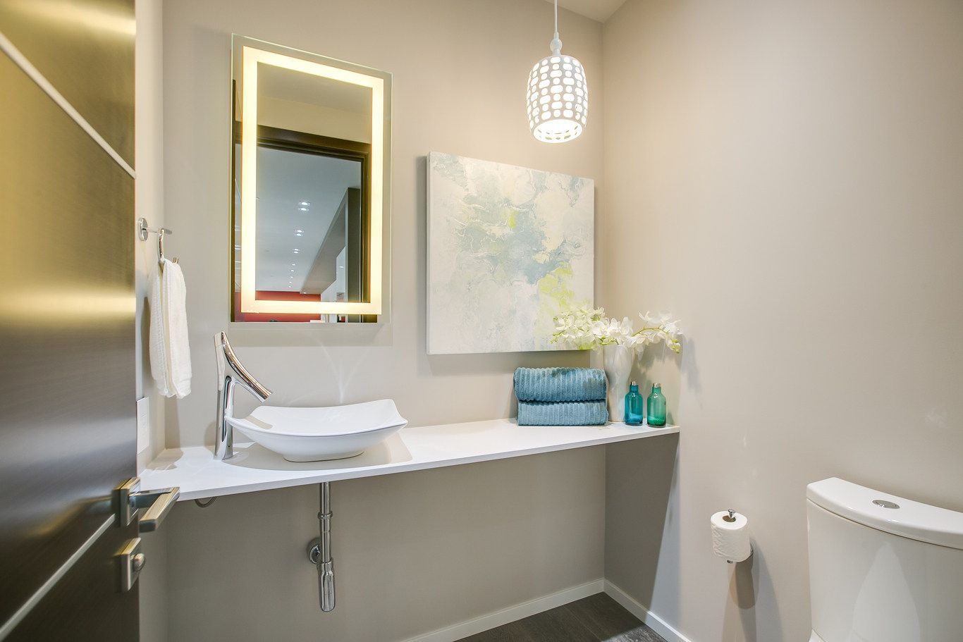 A bathroom with a sink , mirror and toilet.