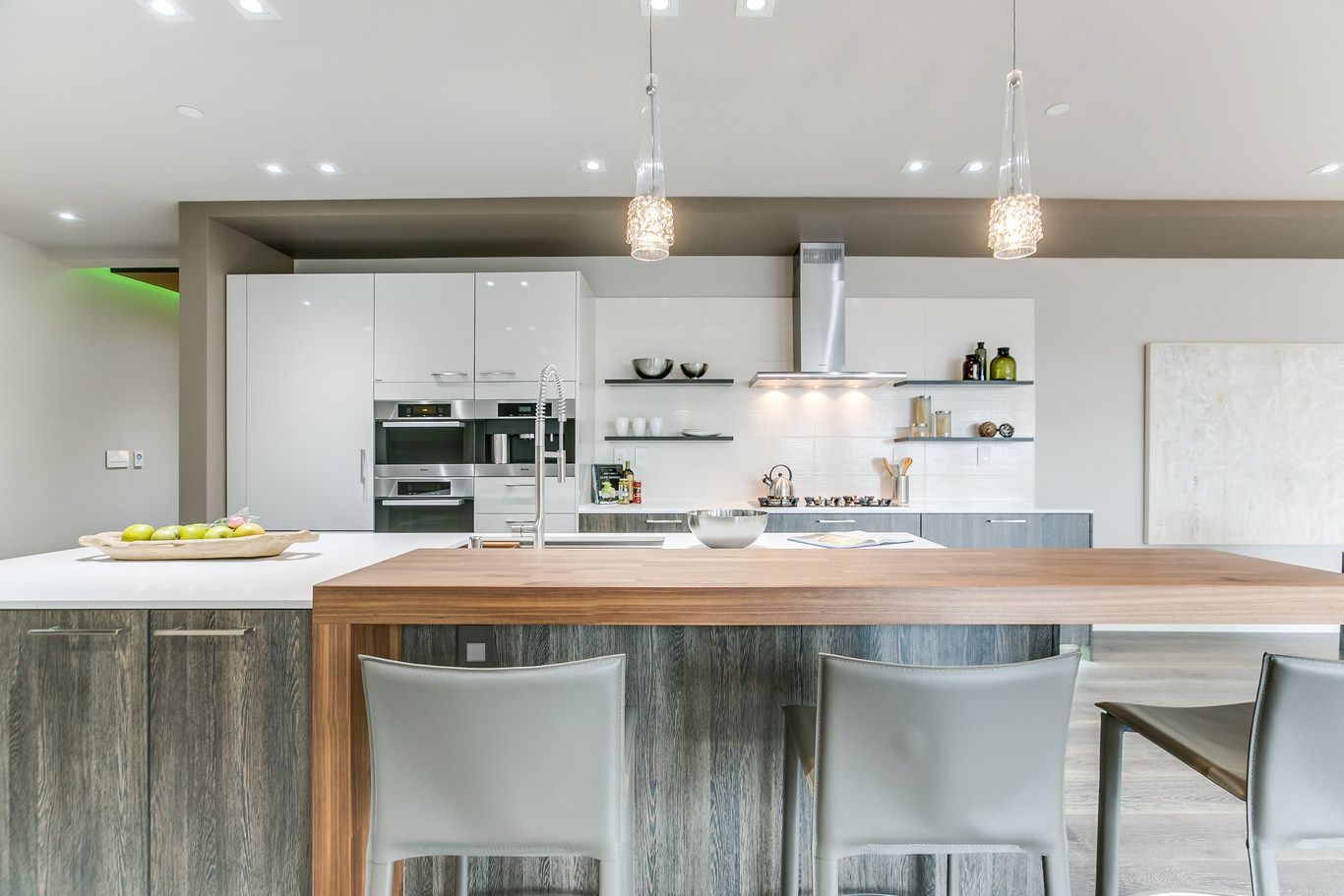 A kitchen with a table and chairs in it