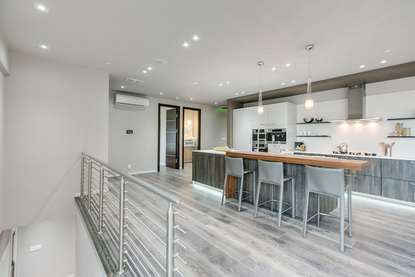 A large kitchen with a large island and stools.