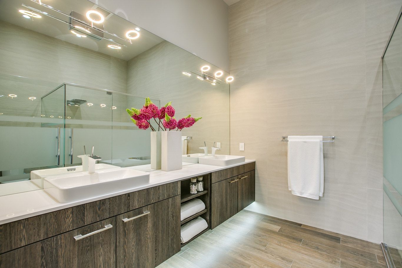 A bathroom with two sinks and a large mirror.