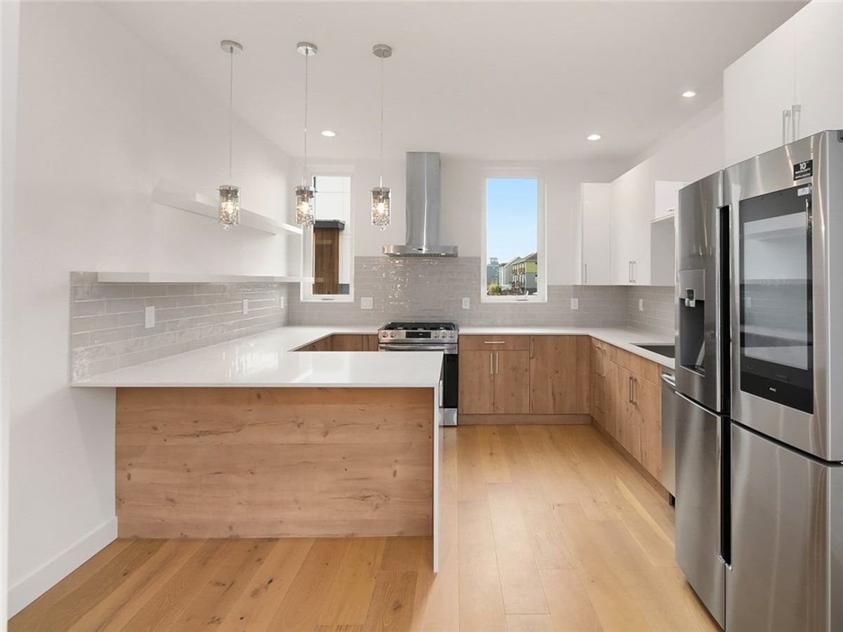 A kitchen with stainless steel appliances and wooden cabinets