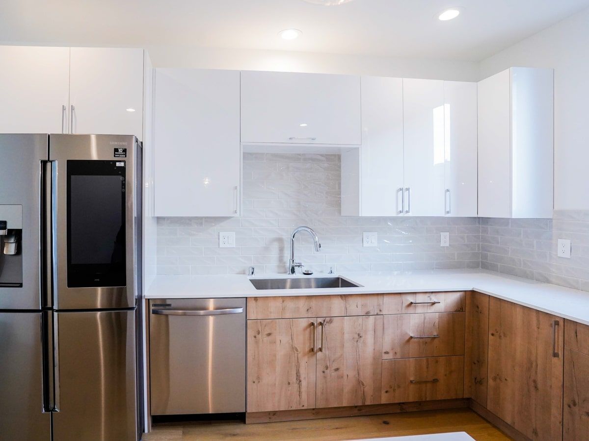 A kitchen with stainless steel appliances and wooden cabinets