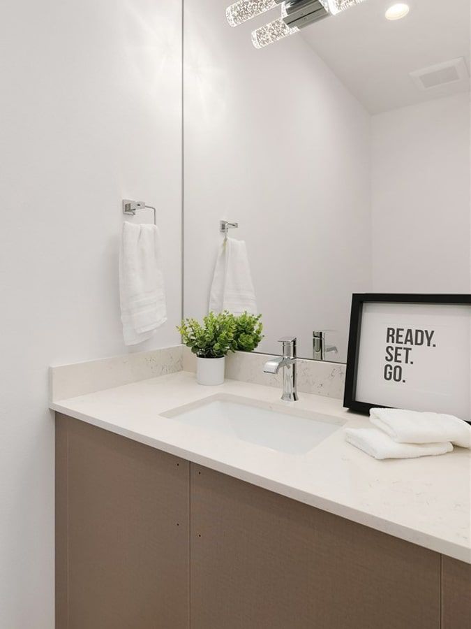 A bathroom with a sink and a sign that says ready set go