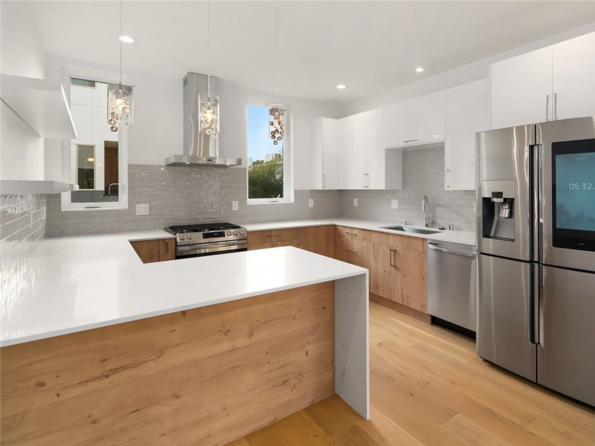 A kitchen with stainless steel appliances and wooden cabinets