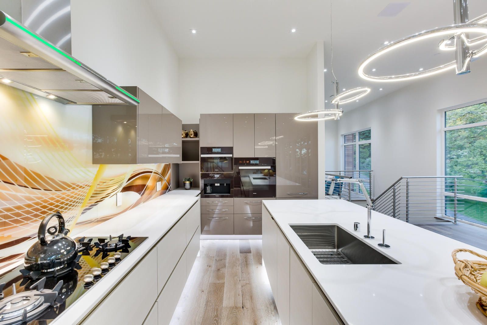 A kitchen with white cabinets and a large sink