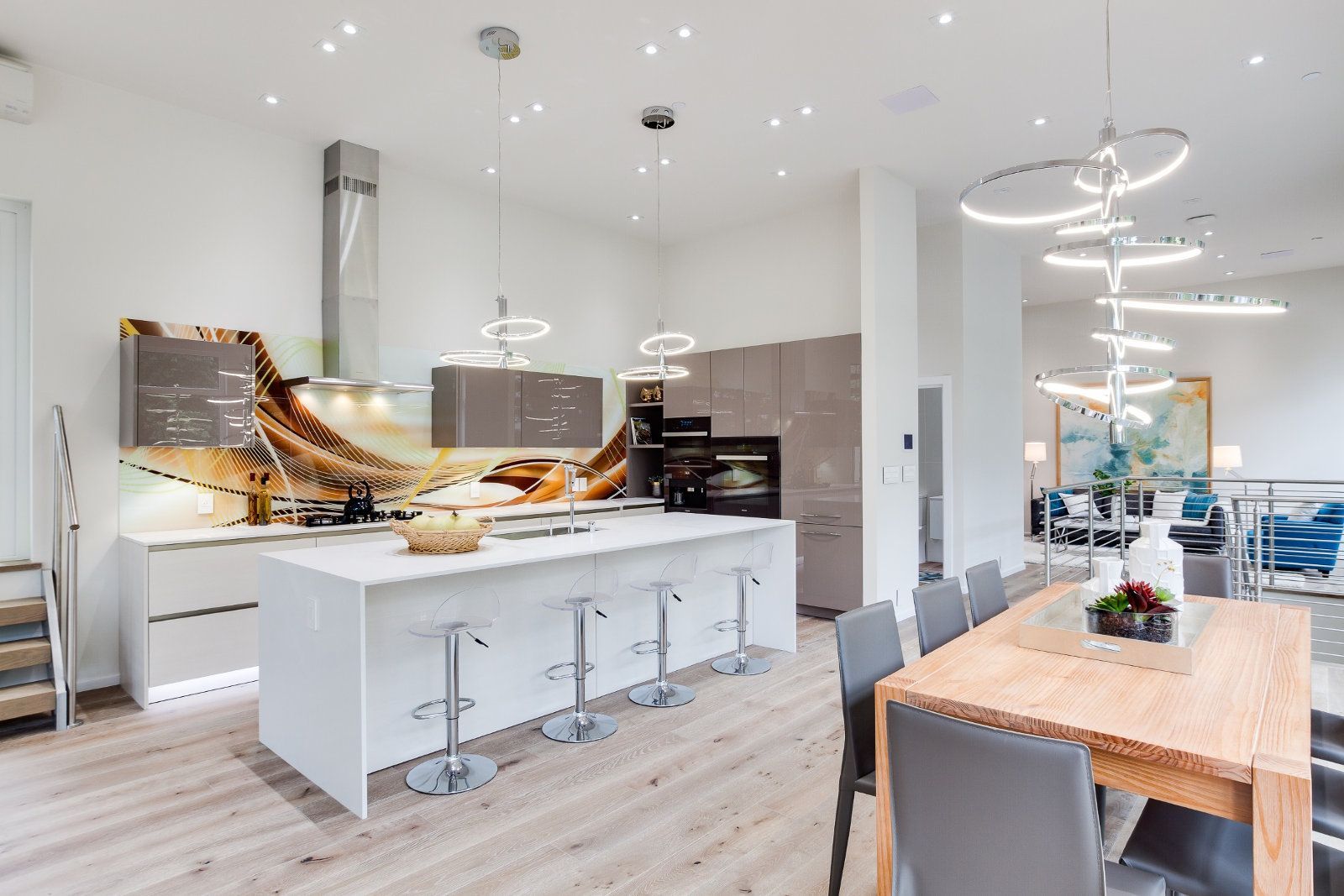 A kitchen with a large island and a dining table.