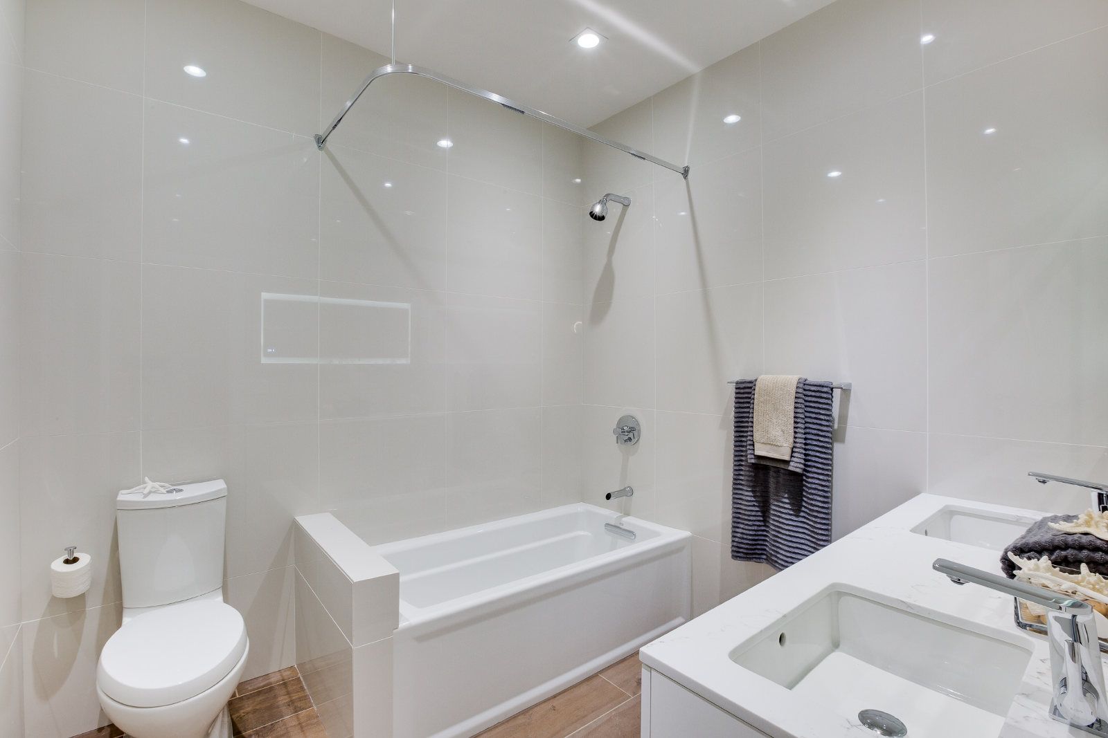 A bathroom with a toilet , sink , bathtub and shower.