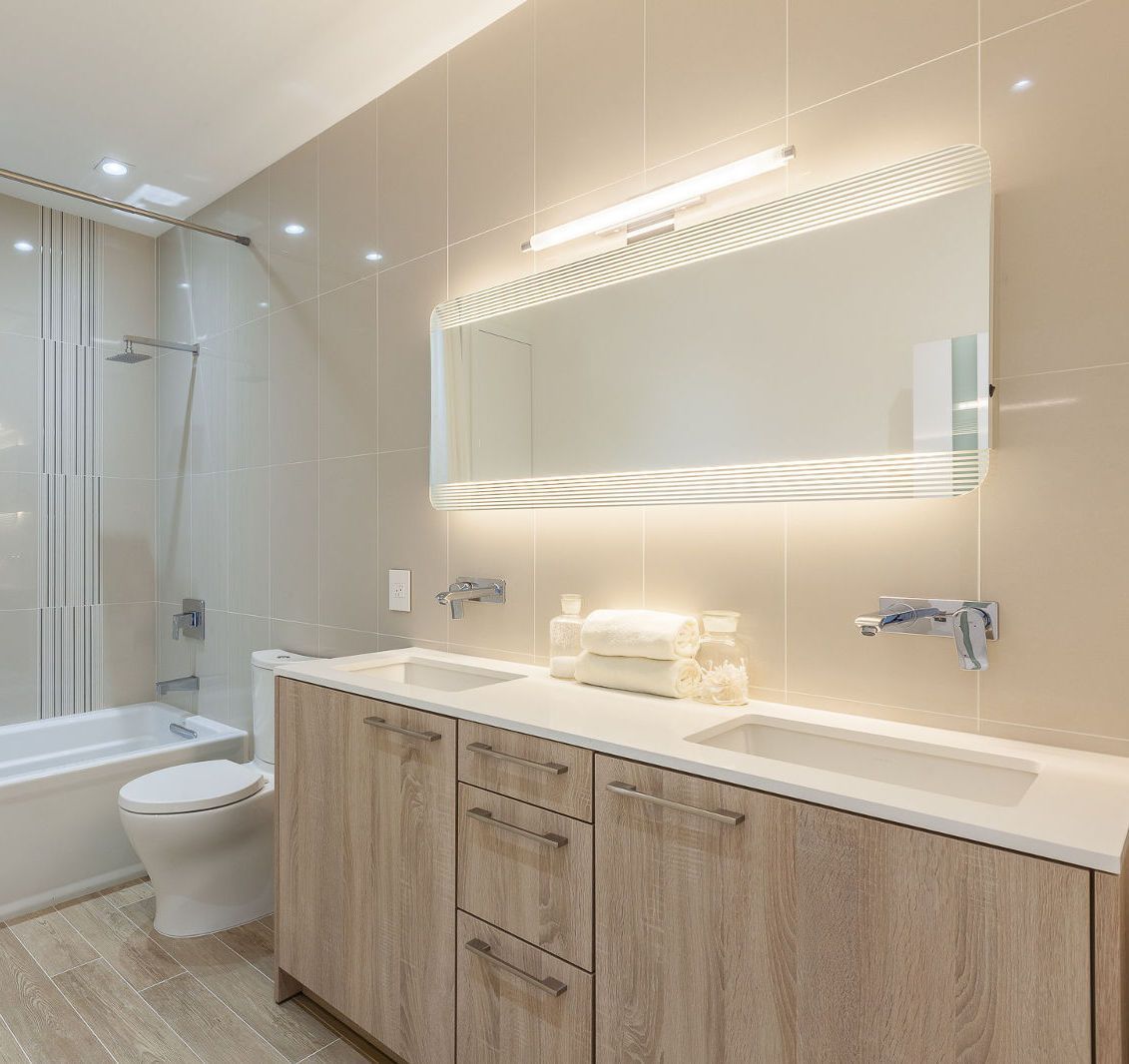 A bathroom with a toilet , sink , and mirror