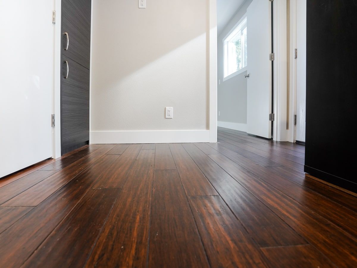 A hallway with hardwood floors and white walls