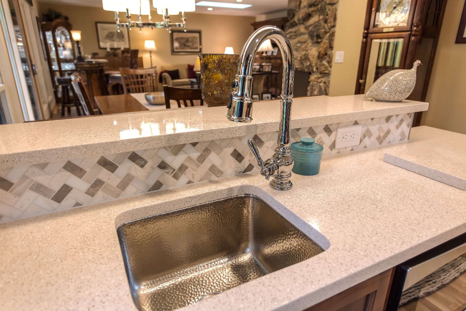 A kitchen with a stainless steel sink and a faucet