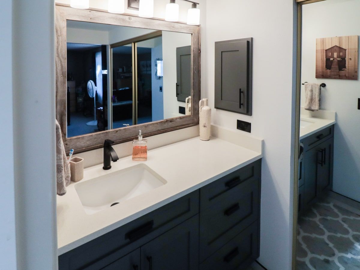 A bathroom with two sinks and a large mirror