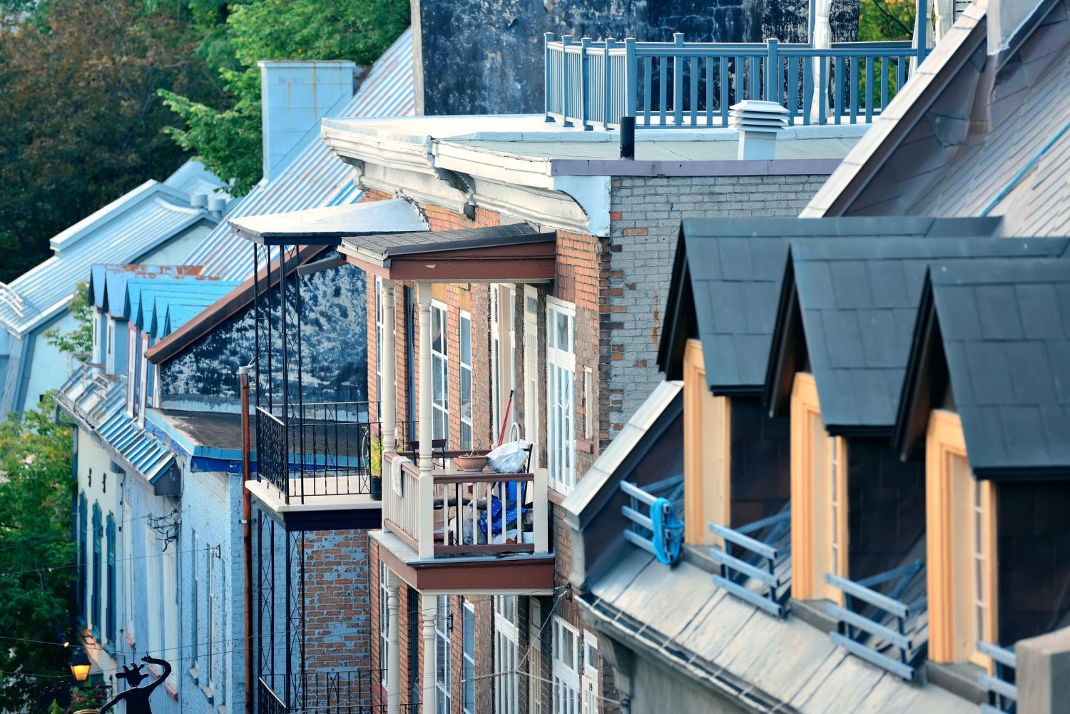 A row of buildings with balconies and a fire escape
