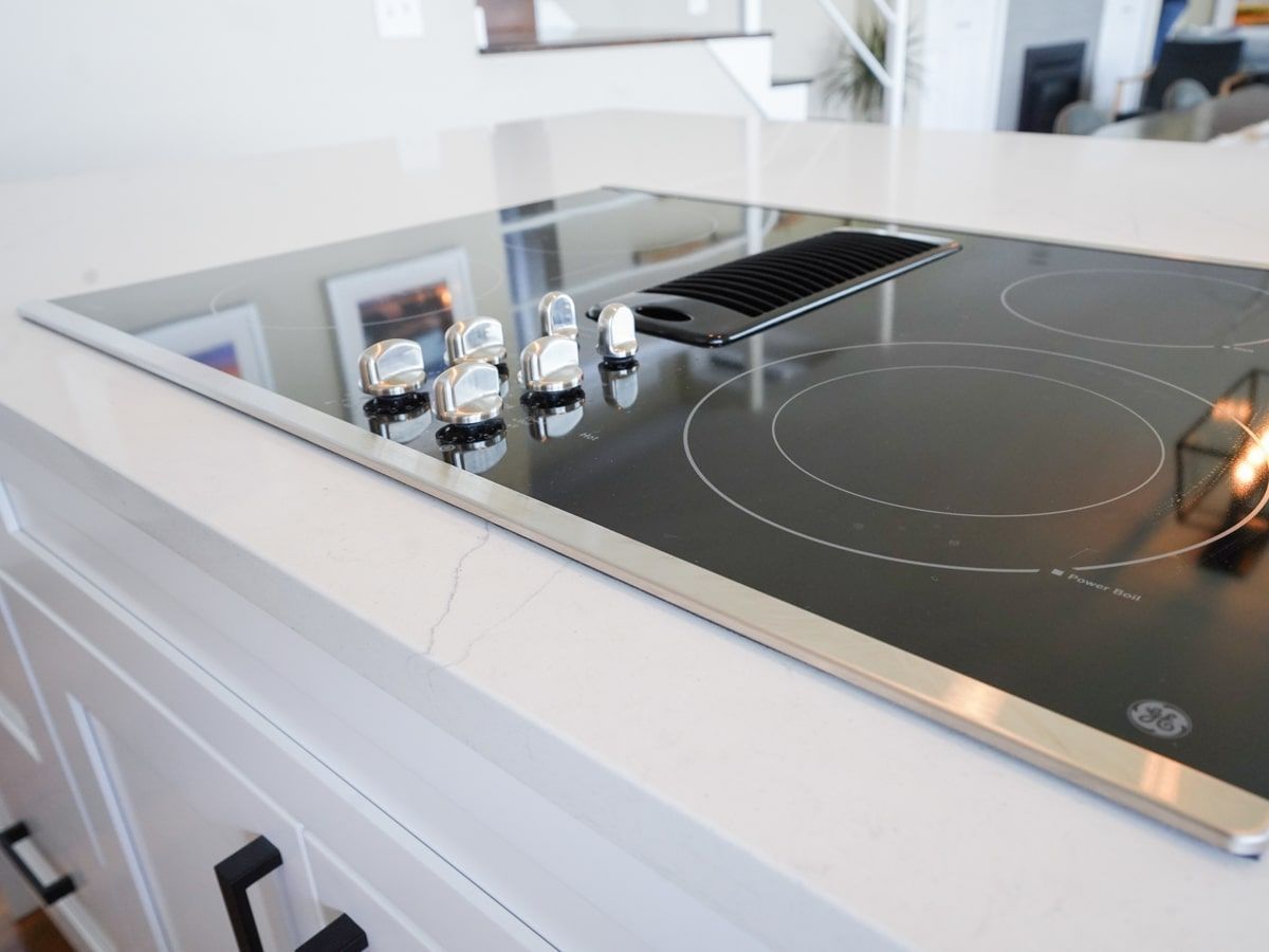 A black stove top with a lg logo on it