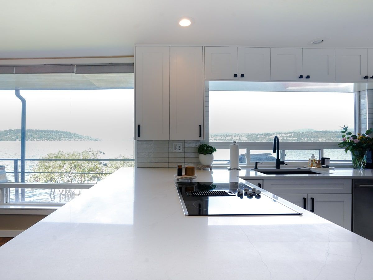 A kitchen with white cabinets and a stove top oven
