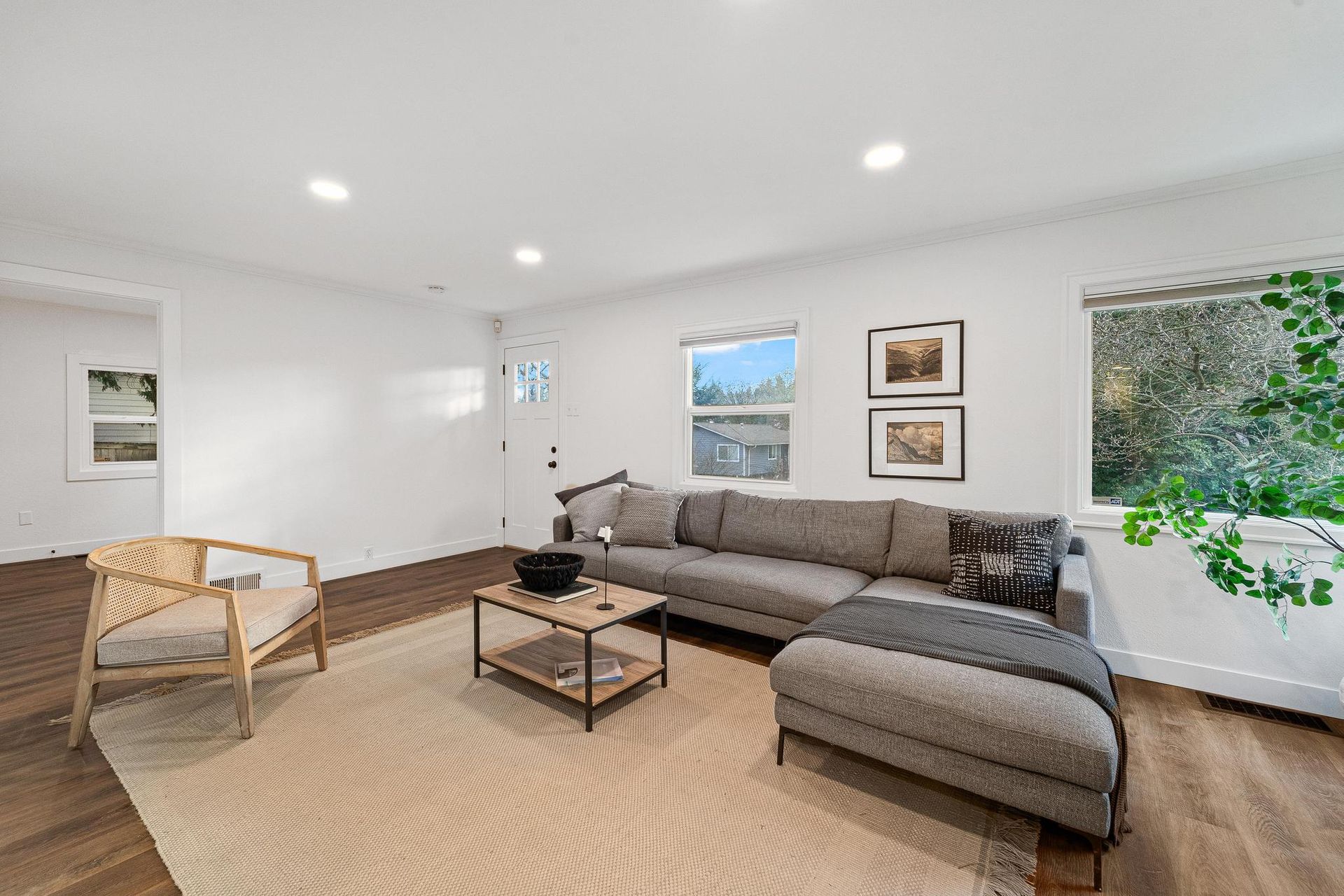 A living room with a couch , chair , coffee table and rug.