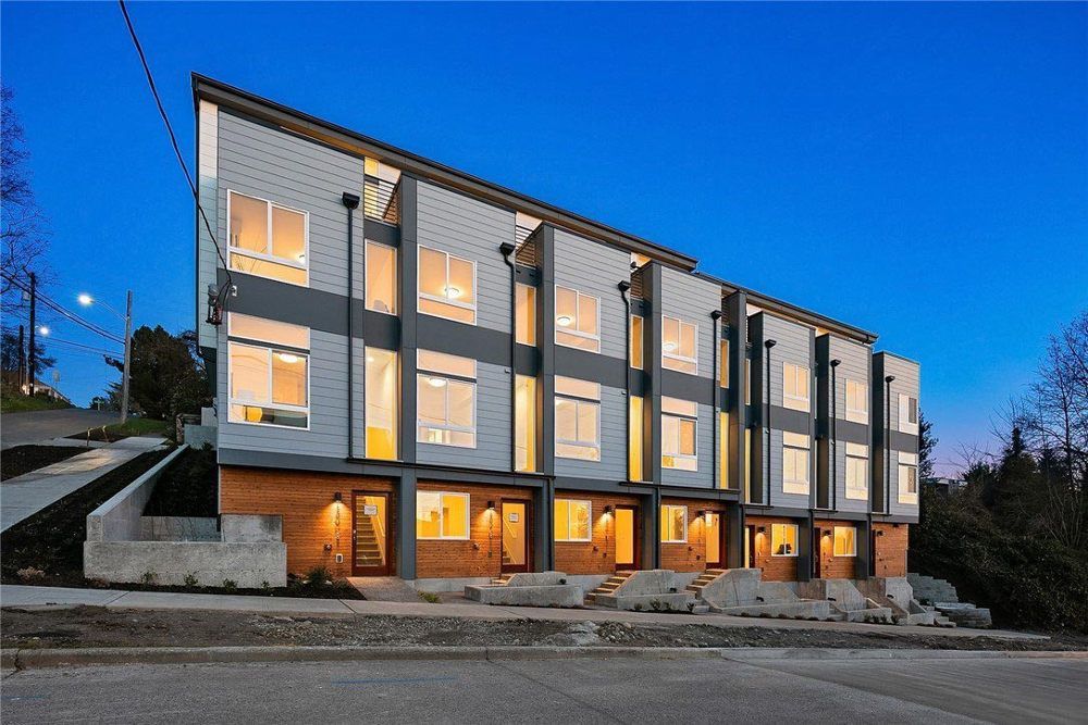 A building with a lot of windows is lit up at night.