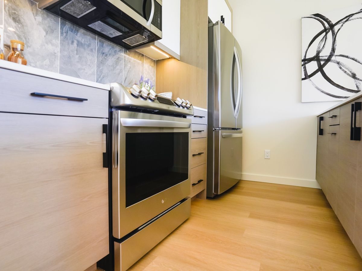 A kitchen with stainless steel appliances and wooden cabinets
