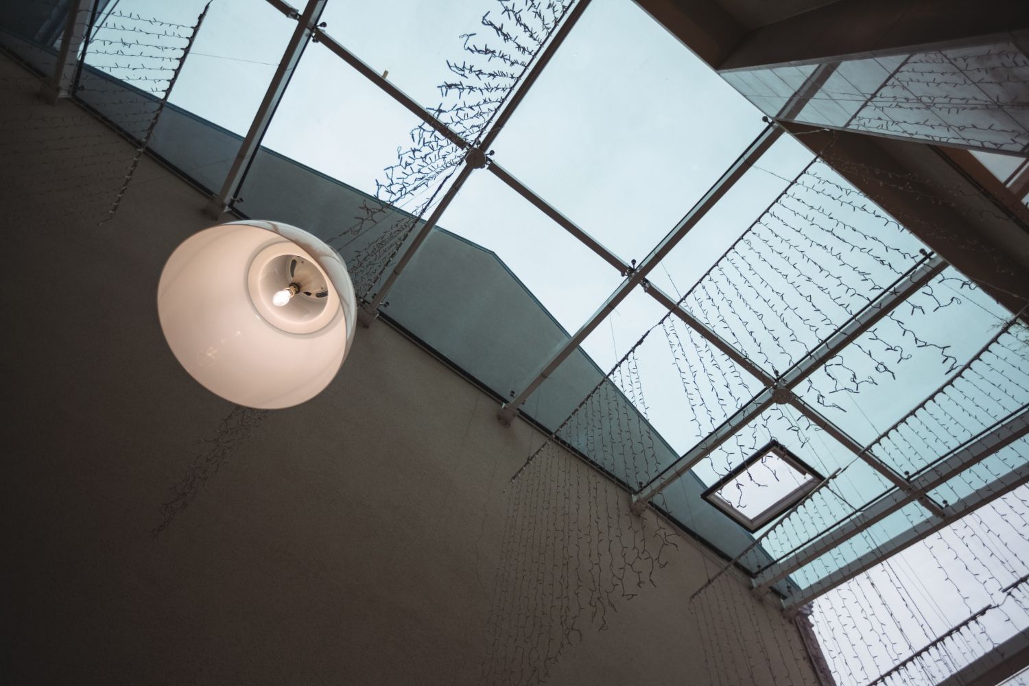 Looking up at a ceiling with a light hanging from it