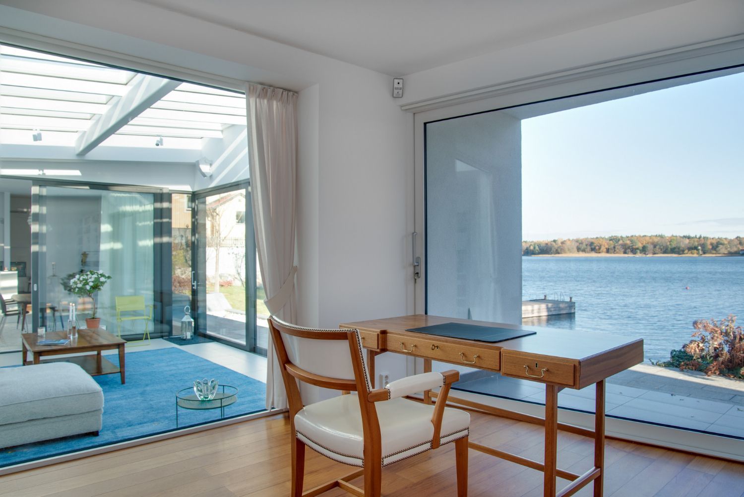 A desk and chair in a room with a view of the water