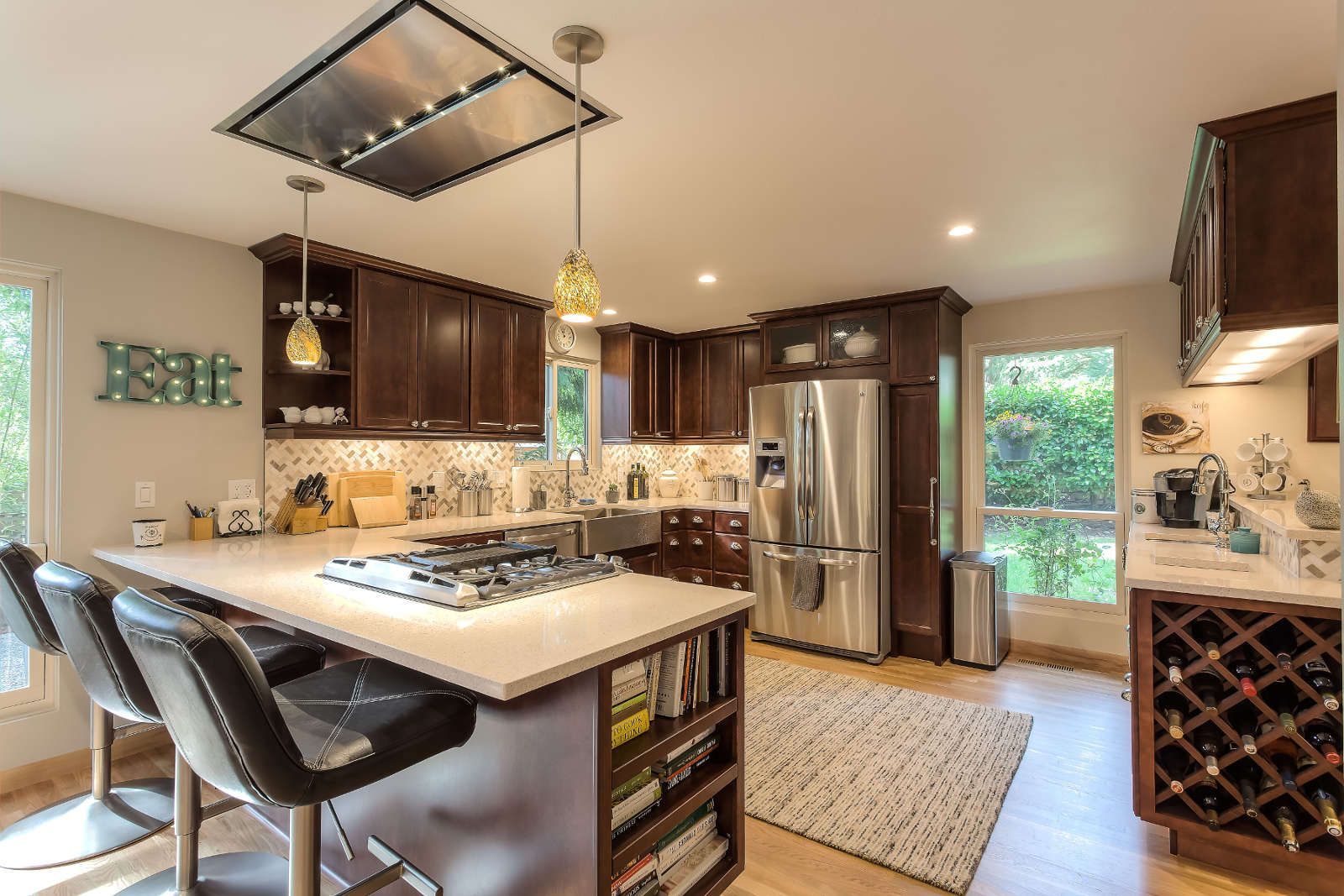 A kitchen with stainless steel appliances and wooden cabinets