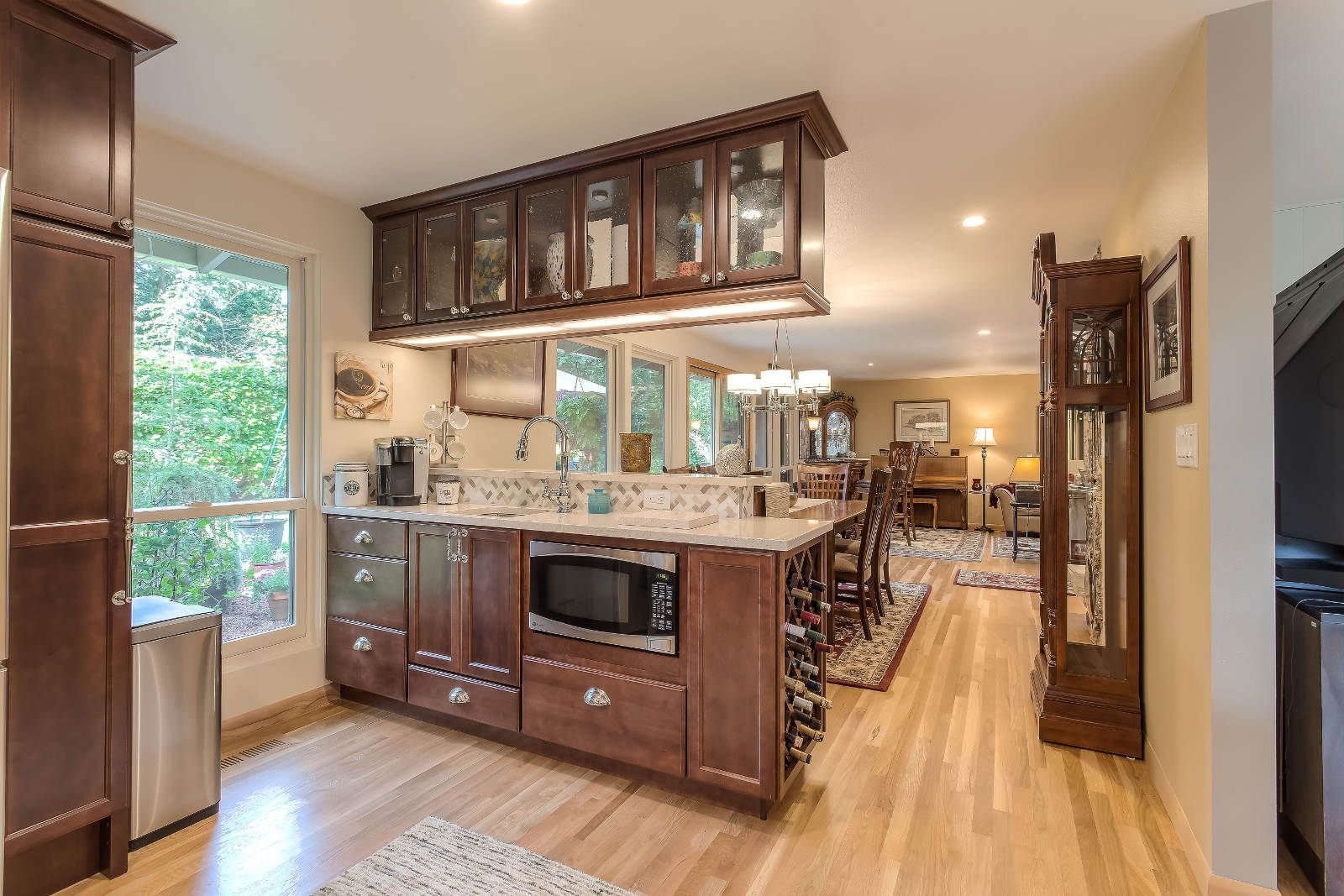 A kitchen with stainless steel appliances and wooden cabinets
